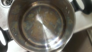 How to remove the black spot above stainless steel pot?