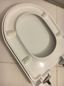 How do you put the old toilet seat down